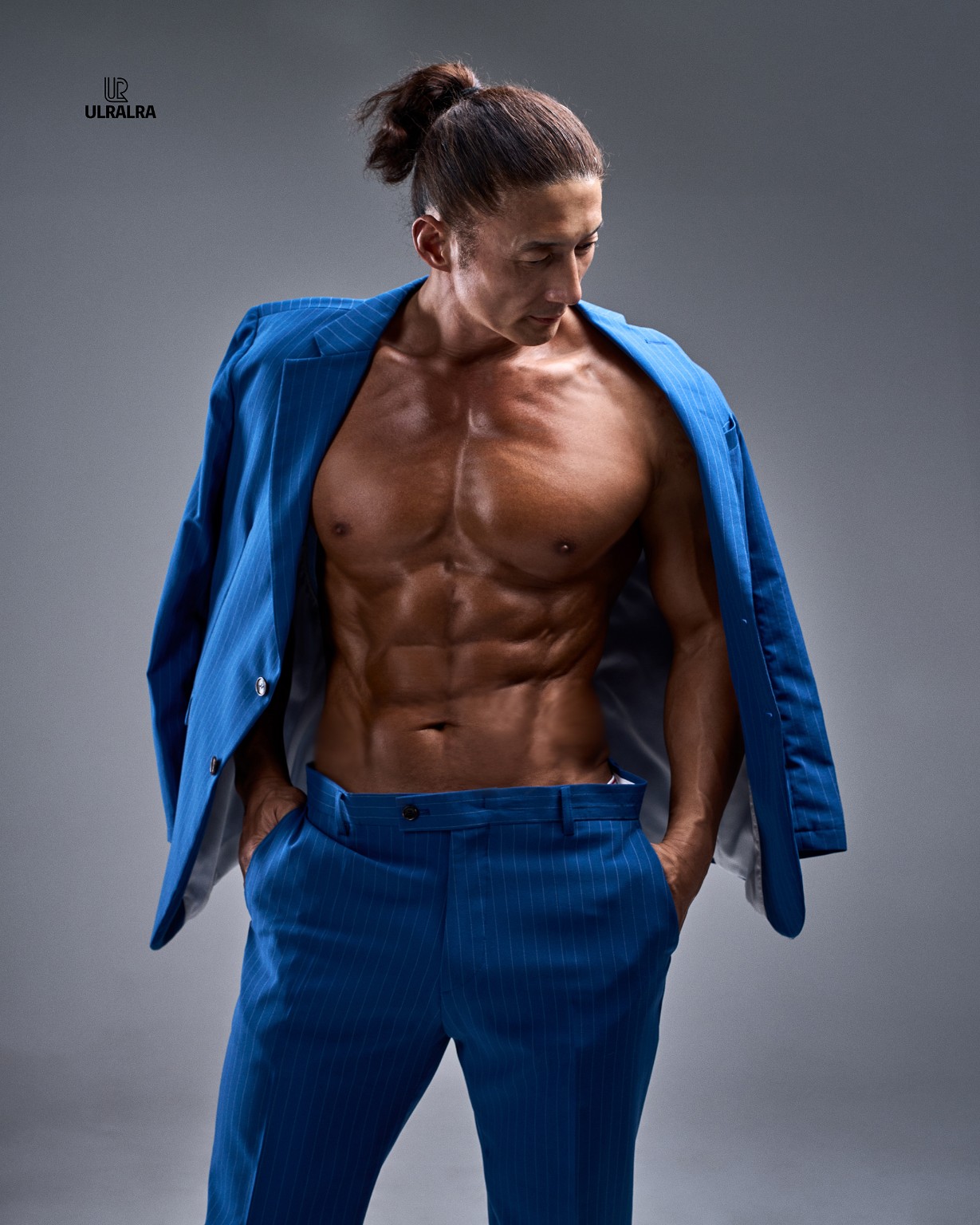 Master Kang wearing a blue jacket in a fitness portrait